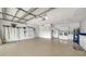 Spacious garage with epoxy floors, washer, dryer, storage cabinets, and utility sink at 4861 Waterbridge Down, Sarasota, FL 34235