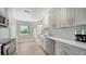 Clean, bright kitchen featuring stainless steel appliances and white cabinets at 4861 Waterbridge Down, Sarasota, FL 34235