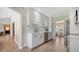 Bright kitchen with white cabinets, stainless appliances, and wood flooring at 4861 Waterbridge Down, Sarasota, FL 34235