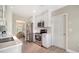 Kitchen with stainless appliances, white cabinetry, and wood-look tile floors at 4861 Waterbridge Down, Sarasota, FL 34235