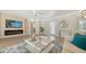 Bright living room featuring a decorative fireplace, modern furniture and a ceiling fan at 4861 Waterbridge Down, Sarasota, FL 34235