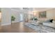 Bright living room with wood floors, stylish rug, and ample seating at 4861 Waterbridge Down, Sarasota, FL 34235
