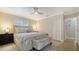 Comfortable main bedroom featuring a ceiling fan, a closet and a soft color palette at 4861 Waterbridge Down, Sarasota, FL 34235