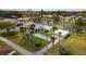 Aerial view showcasing community amenities, including a pool, shuffleboard, and a pond at 5057 Live Oak Cir # 86, Bradenton, FL 34207