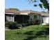 Backyard featuring a screened porch, green lawn, and lush garden at 5057 Live Oak Cir # 86, Bradenton, FL 34207