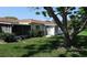 Well-maintained backyard with lush grass, mature trees, and a screened lanai at 5057 Live Oak Cir # 86, Bradenton, FL 34207