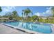 Community pool with clear blue water, poolside seating, and well-maintained landscaping, perfect for relaxation and recreation at 5057 Live Oak Cir # 86, Bradenton, FL 34207
