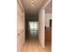 Hallway view featuring tile floors, a coat closet, and light-filled rooms at 5057 Live Oak Cir # 86, Bradenton, FL 34207