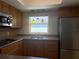Kitchen featuring wooden cabinets, stainless steel appliances, and pendant lights at 5057 Live Oak Cir # 86, Bradenton, FL 34207