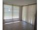 Bright screened in patio with tile flooring and adjustable vertical blinds at 5057 Live Oak Cir # 86, Bradenton, FL 34207