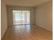 Empty living room with tiled floors and sliding glass doors leading to an enclosed patio at 5057 Live Oak Cir # 86, Bradenton, FL 34207