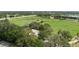 Beautiful aerial view showcasing a home nestled within a serene landscape with pond and surrounding green space at 5403 Red Rooster Rd, Parrish, FL 34219