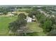 A lovely aerial view of a home featuring lush landscaping, surrounding green space, and a perimeter fence at 5403 Red Rooster Rd, Parrish, FL 34219