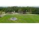 Aerial view of home with detached garage, surrounded by lush greenery and a white fence at 5403 Red Rooster Rd, Parrish, FL 34219