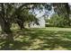 Expansive backyard framed by mature trees offering privacy and shade at 5403 Red Rooster Rd, Parrish, FL 34219