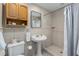 Updated bathroom featuring a vanity sink, toilet, and walk-in shower with neutral tiling and a light blue shower curtain at 5403 Red Rooster Rd, Parrish, FL 34219