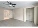 This bedroom features neutral walls, carpet flooring, a ceiling fan, multiple doors, and closet space at 5403 Red Rooster Rd, Parrish, FL 34219