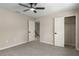 This bedroom features neutral walls, carpet flooring, a ceiling fan, multiple doors, and closet space at 5403 Red Rooster Rd, Parrish, FL 34219