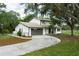 Beautiful two-story home with gray two-car garage, dark roof and a well-manicured lawn at 5403 Red Rooster Rd, Parrish, FL 34219
