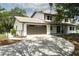 Lovely property featuring a charming home, driveway, mature landscaping, and an attached two-car garage at 5403 Red Rooster Rd, Parrish, FL 34219