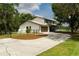 Charming two-story home boasting a well-manicured lawn, concrete driveway and mature landscaping at 5403 Red Rooster Rd, Parrish, FL 34219