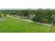 Aerial view of a home in a sprawling green landscape with a white fence at 5403 Red Rooster Rd, Parrish, FL 34219