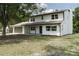Charming two-story home with a fresh coat of white paint and well-manicured lawn at 5403 Red Rooster Rd, Parrish, FL 34219