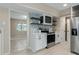 Stylish kitchen boasting floating shelves, stainless steel range, and white cabinetry at 5403 Red Rooster Rd, Parrish, FL 34219