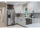 Modern kitchen features white cabinets, stainless steel appliances, and mosaic backsplash at 5403 Red Rooster Rd, Parrish, FL 34219