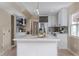 Open kitchen design with a large island, white cabinetry, and modern appliances at 5403 Red Rooster Rd, Parrish, FL 34219