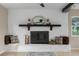 Cozy living room with stone fireplace, decorative mantle, and comfortable seating at 5403 Red Rooster Rd, Parrish, FL 34219