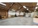 Large workshop with open ceiling and concrete flooring with work benches and multiple tables at 5403 Red Rooster Rd, Parrish, FL 34219