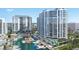Expansive aerial view showcasing waterfront condos, a marina, and recreational amenities, offering a luxury coastal lifestyle at 555 Quay Cmn # 405, Sarasota, FL 34236
