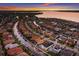 Beautiful aerial view of a waterfront home with a private boat dock and stunning sunset at 569 Mast Dr, Bradenton, FL 34208