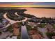 Breathtaking aerial view of waterfront homes along winding canals, featuring stunning sunset and luxurious residences at 569 Mast Dr, Bradenton, FL 34208
