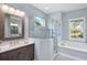 Bright bathroom with a glass-enclosed shower, soaking tub, and stylish vanity with a framed mirror at 569 Mast Dr, Bradenton, FL 34208