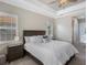 This bedroom features a tray ceiling, ceiling fan, carpet floors, and a king bed at 569 Mast Dr, Bradenton, FL 34208