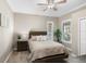 Cozy bedroom features a ceiling fan, carpet, and a wooden bed dressed with decorative pillows at 569 Mast Dr, Bradenton, FL 34208