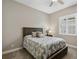 Comfortable bedroom featuring carpet and a rustic wooden bed frame dressed with decorative pillows and a palm patterned comforter at 569 Mast Dr, Bradenton, FL 34208