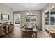 Dining area featuring wood floors, stylish chandelier, and sliding glass doors leading to outdoor pool area at 569 Mast Dr, Bradenton, FL 34208