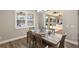 Dining area with wood floors, plantation shutters, and sliding glass doors leading to outdoor patio and entertainment area at 569 Mast Dr, Bradenton, FL 34208
