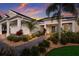 Well-manicured home exterior with lush landscaping and a paver walkway at 569 Mast Dr, Bradenton, FL 34208