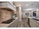 Modern kitchen features stainless steel appliances, gray cabinets, granite counters, and brick backsplash at 569 Mast Dr, Bradenton, FL 34208