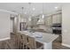 Modern kitchen with gray cabinets, stainless steel appliances, large island, and pendant lighting at 569 Mast Dr, Bradenton, FL 34208