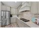 Modern kitchen features stainless steel appliances, light granite countertops, tile backsplash and ample counter space at 569 Mast Dr, Bradenton, FL 34208