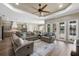 Spacious living room featuring neutral tones, modern furniture, and sliding glass doors to the pool at 569 Mast Dr, Bradenton, FL 34208