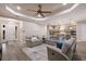 Spacious living room open to the kitchen, featuring stylish seating, tray ceiling, and modern decor at 569 Mast Dr, Bradenton, FL 34208