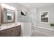 Bright modern main bathroom features a glass shower, soaking tub, and designer vanity at 569 Mast Dr, Bradenton, FL 34208