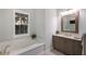 Comfortable main bathroom features a soaking tub, designer vanity, and light blocking shutters at 569 Mast Dr, Bradenton, FL 34208