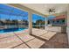 Covered patio with outdoor kitchen and screened-in pool provides relaxing outdoor living at 569 Mast Dr, Bradenton, FL 34208